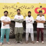 Another group of the Qurbani distribution team in front of a truck during Eid al-Adha 2024, ready to visit different towns.